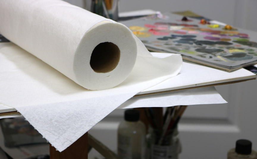paper towels on an artist table with paints