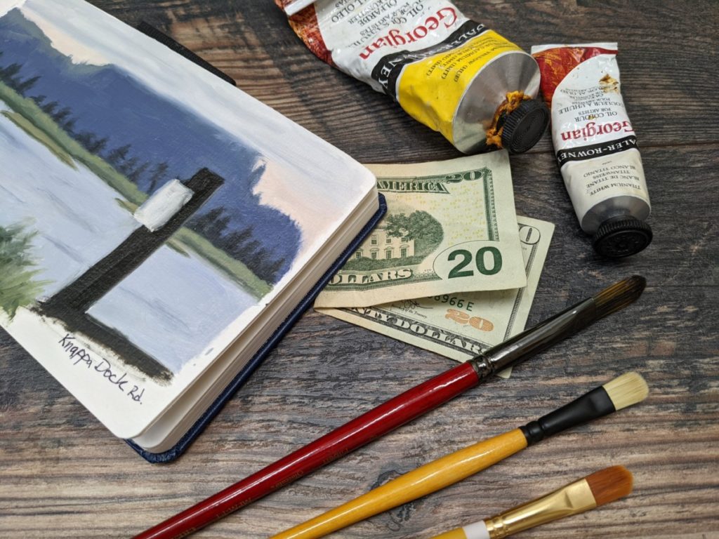 group of art supplies with a $20 bill