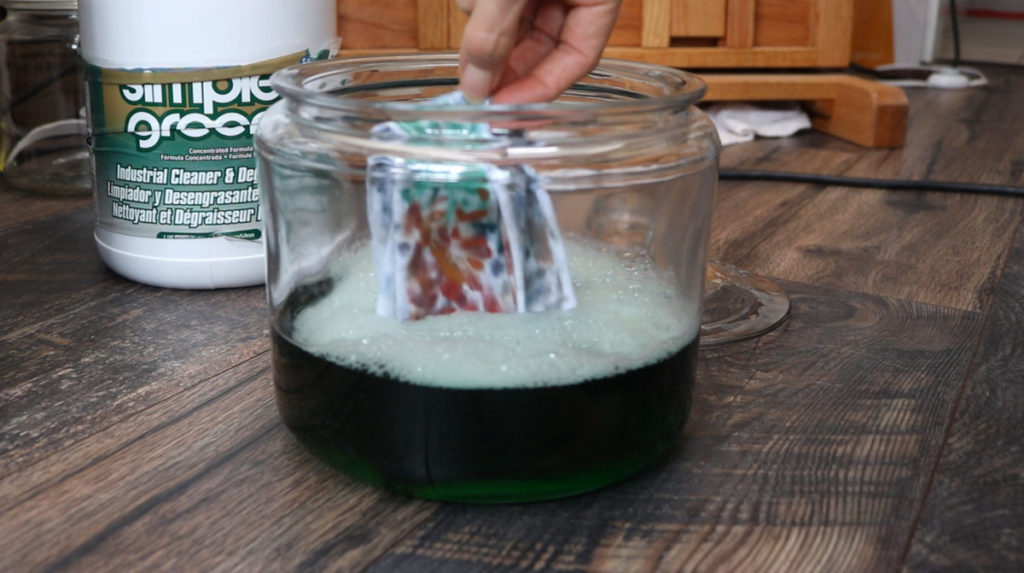 Dropping Oil Paint rags into a glass jar of Simple Green